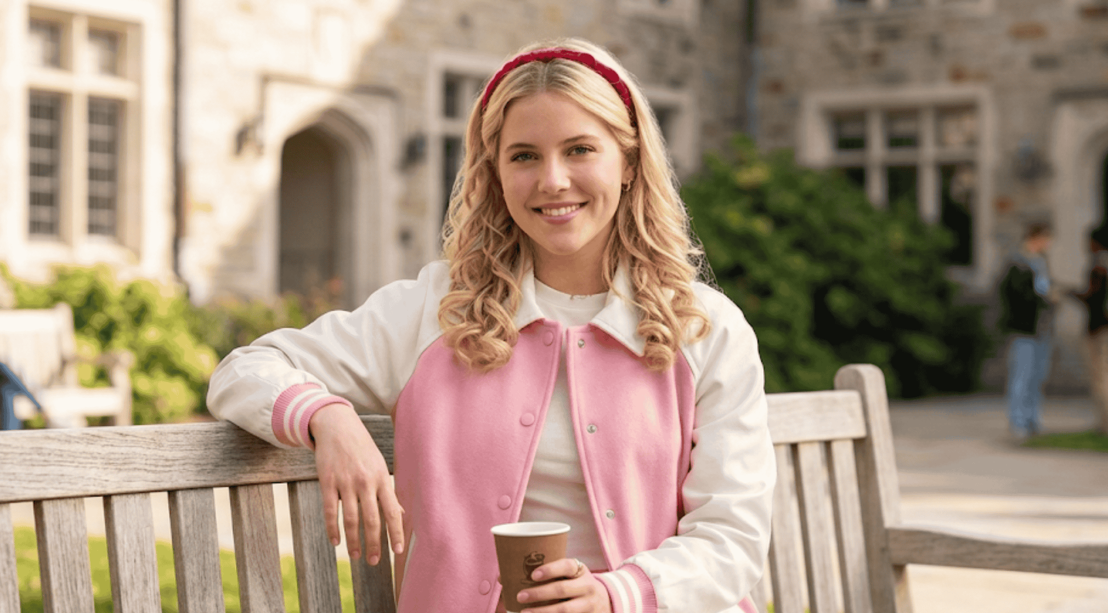 Lexi Minetree Elle Season 1 pink and white varsity jacket with large white heart-shaped patch pockets and a pointed collar.